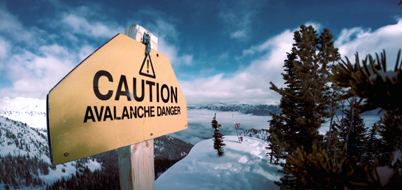 View of avalanche warning sign on top of mountain.